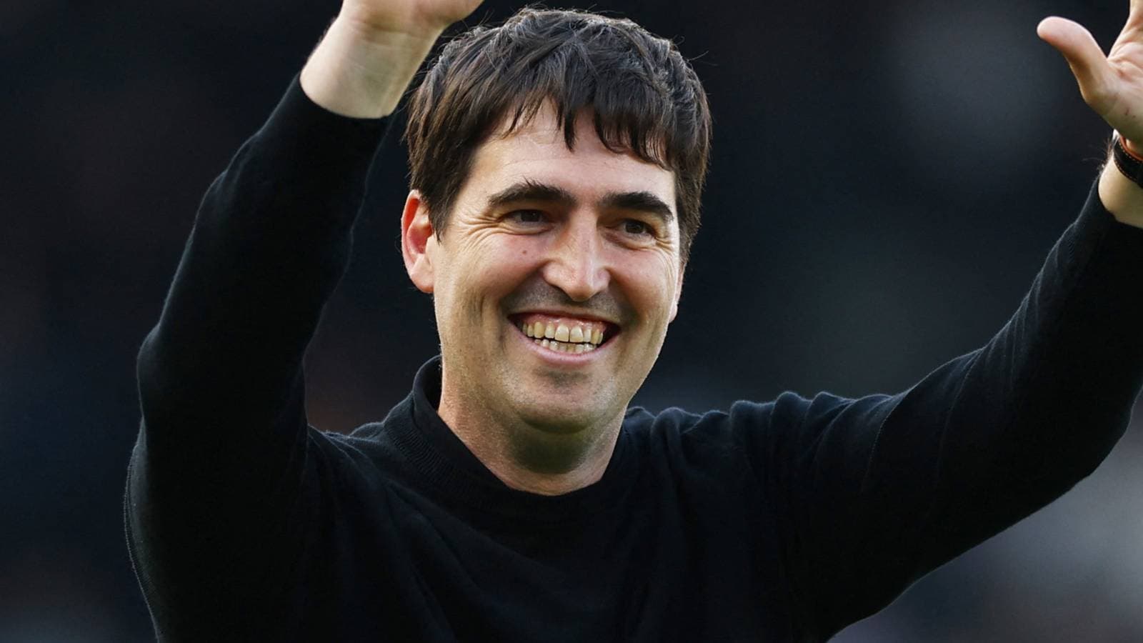 Coach waving to fans during match celebration