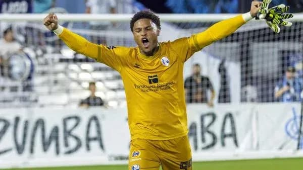 Goalkeeper celebrating a save in front of fans