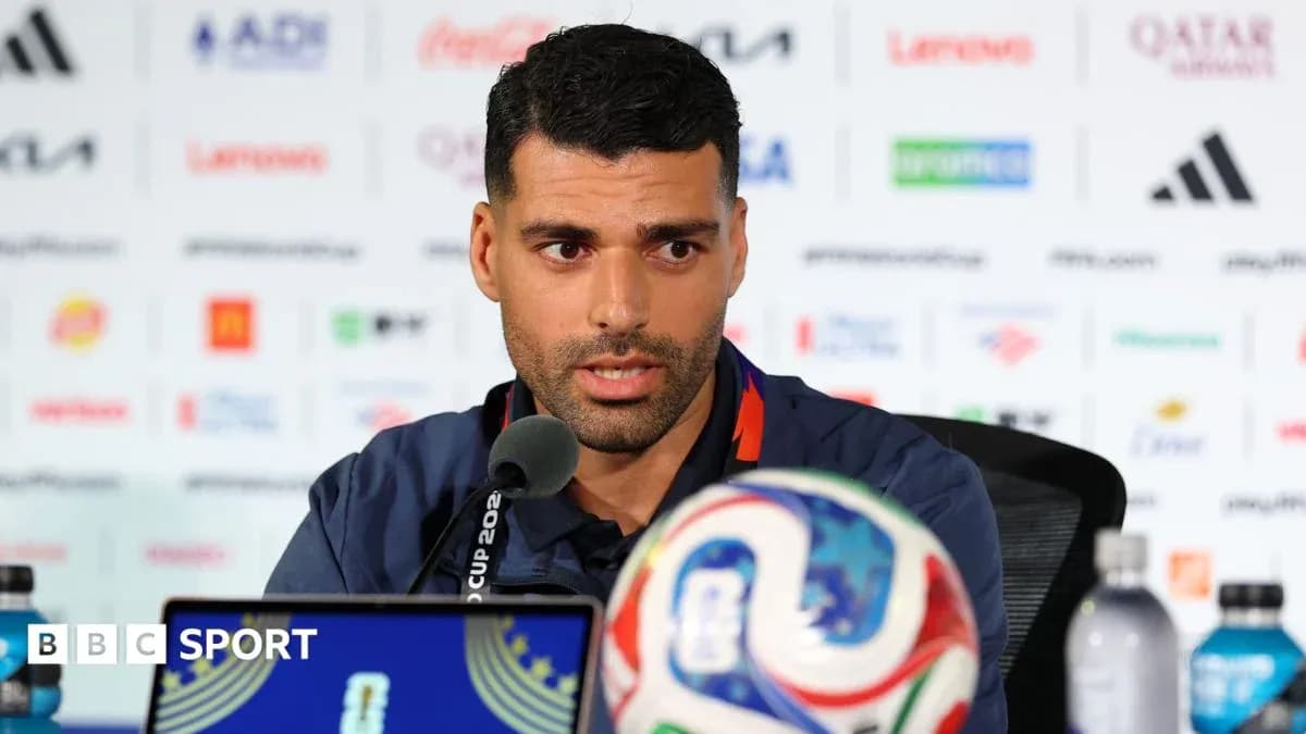Player speaking at press conference with football