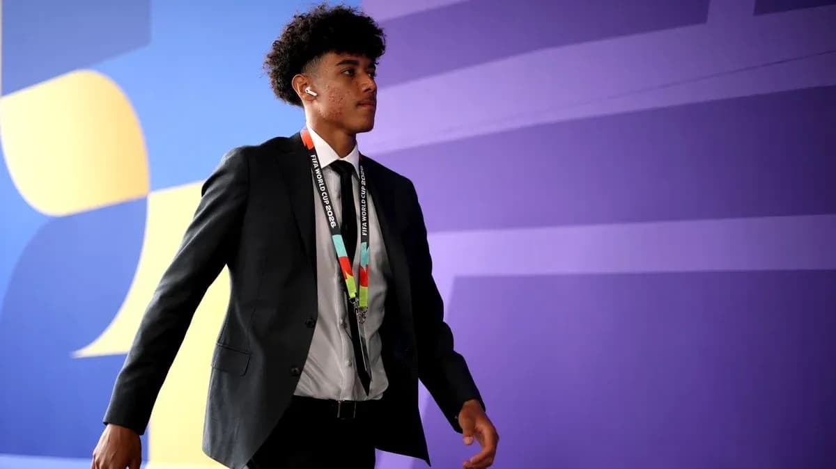 Player walking in suit with FIFA World Cup credentials