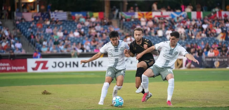 Players competing for the ball in USL Championship