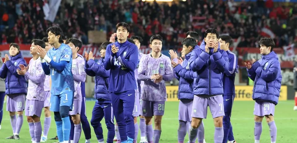 Team applauding fans after match in stadium