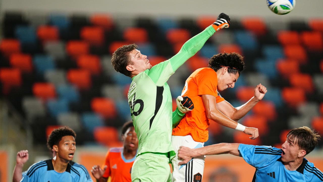 Goalkeeper punching the ball during match action