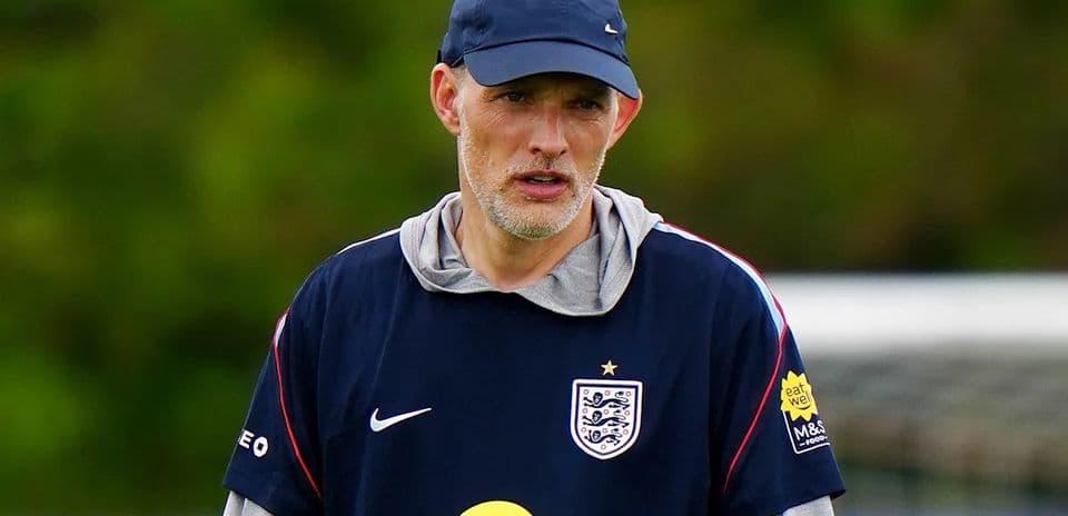 Coach observing training session on the pitch