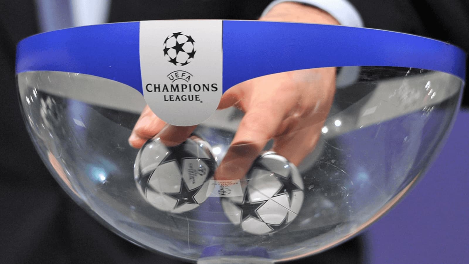 Hand drawing balls from UEFA Champions League bowl