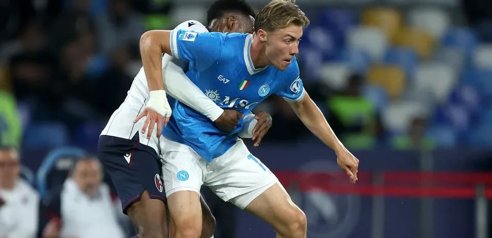 Napoli player being challenged by opponent during match