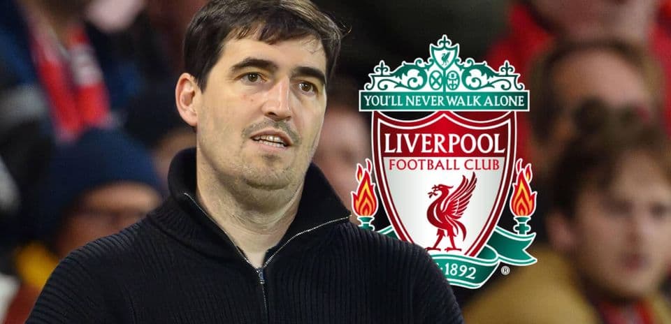 Individual standing in front of Liverpool FC logo