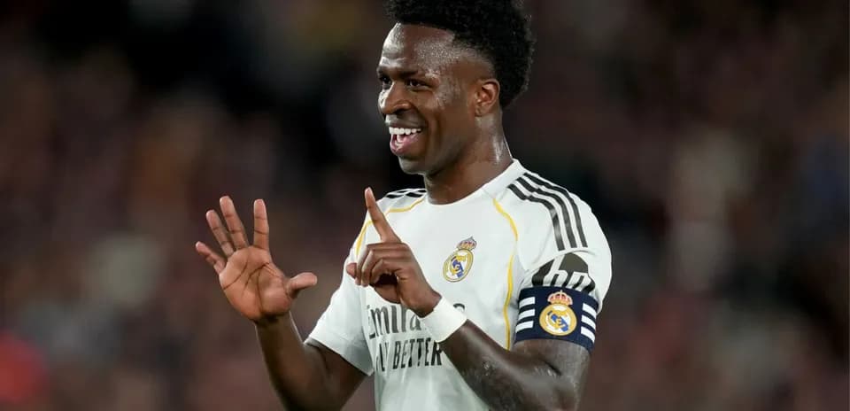 Player celebrating during a match wearing Real Madrid kit