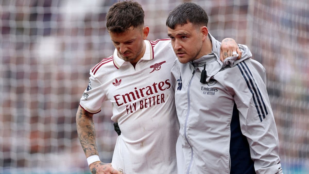 Player receiving assistance from medical staff on field