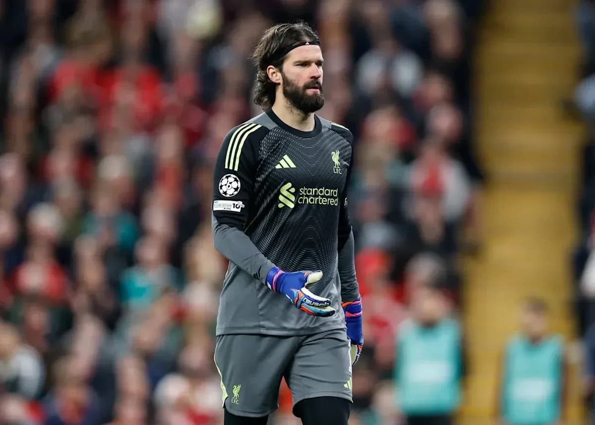 Goalkeeper in Liverpool kit walking on the pitch
