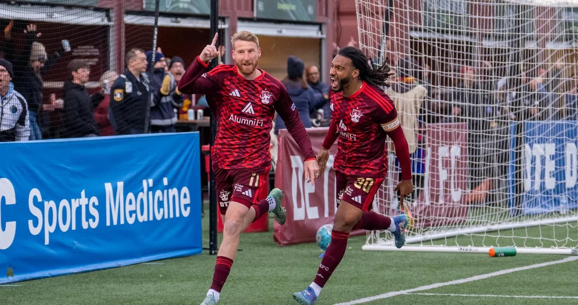 Players celebrating goal in USL League One match
