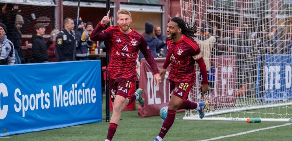 Players celebrating goal in USL League One match
