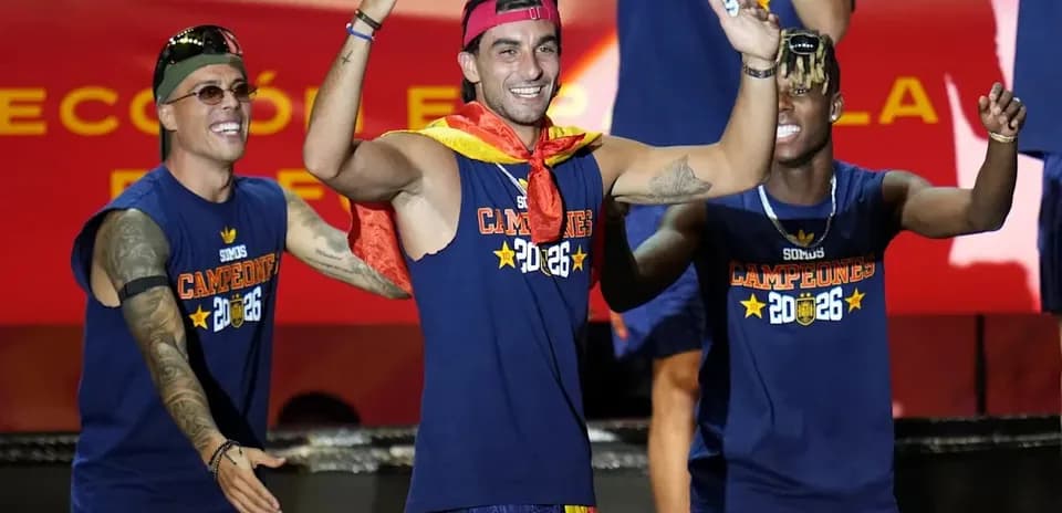 Players celebrating on stage with medals and flags