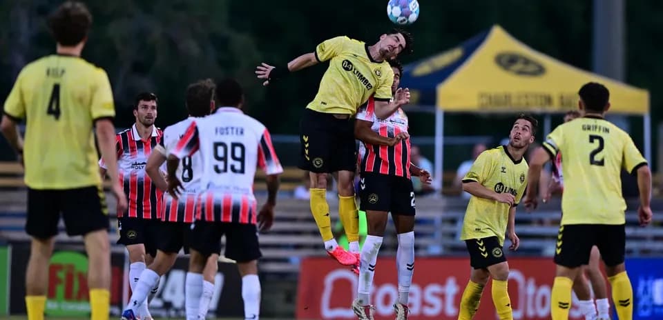 Player heading the ball during Charleston Battery match