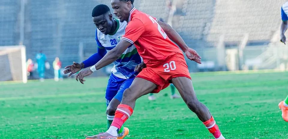 Two players contesting for the ball during match