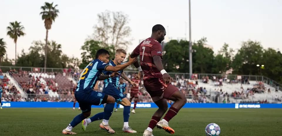 Two players competing for the ball during match