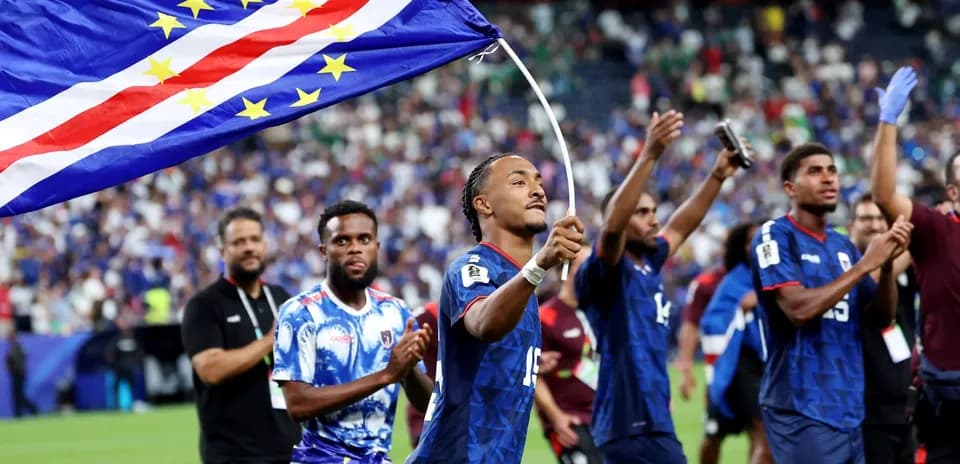 Players celebrating with Cape Verde flag after match