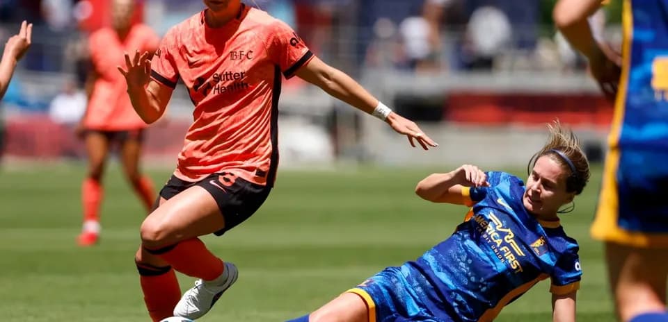 Bay FC player dribbling past Utah Royals defender