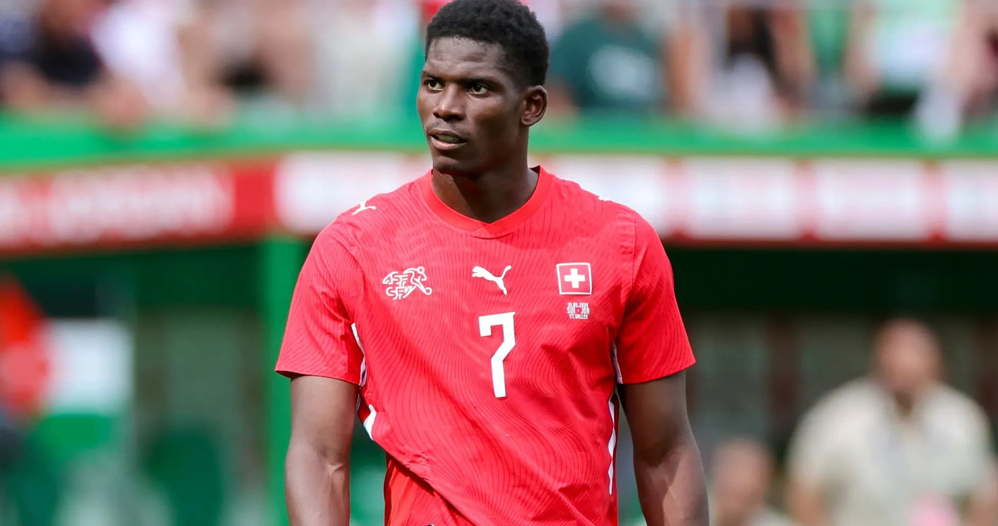 Player wearing red Swiss national team jersey on field