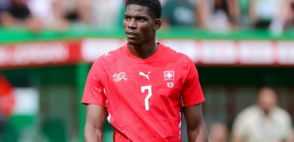 Player wearing red Swiss national team jersey on field
