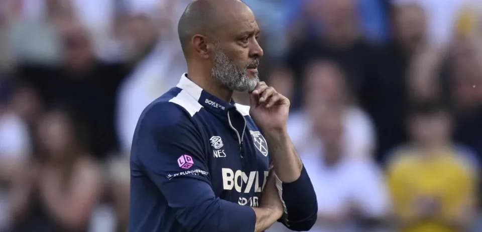 Coach observing the match with thoughtful expression