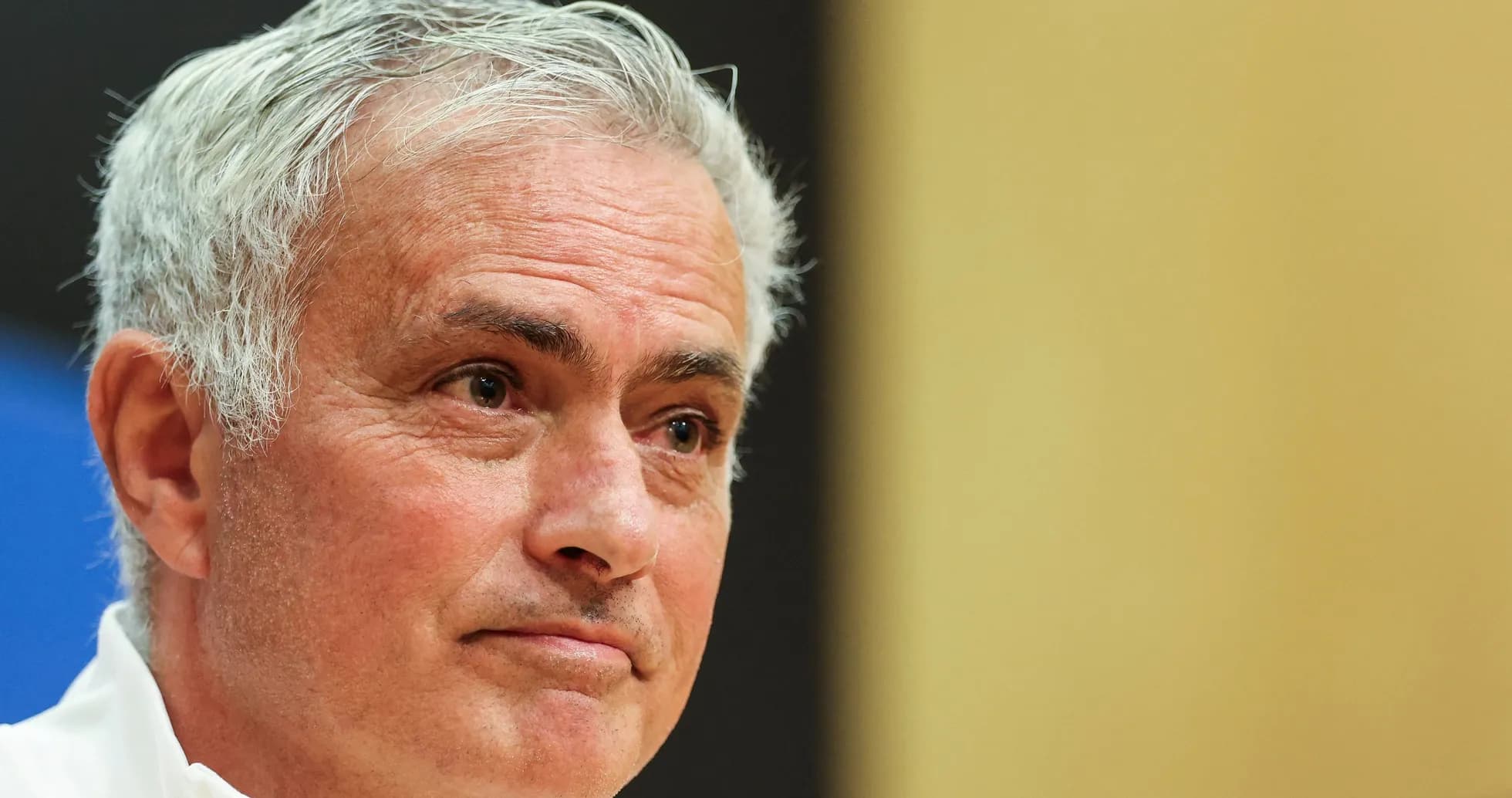 Manager speaking at press conference with neutral background