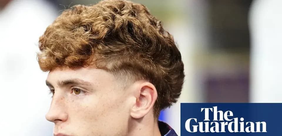 Young man with curly hair in profile view
