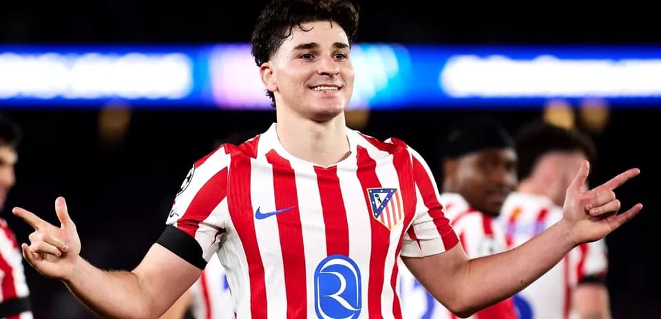 Player celebrating in Atletico Madrid jersey after match