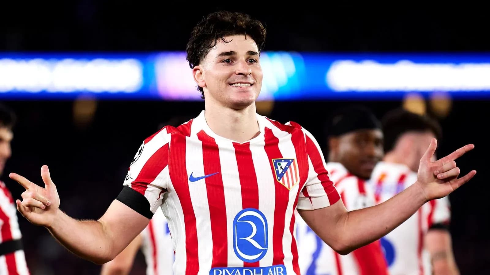 Player celebrating in Atletico Madrid jersey after match
