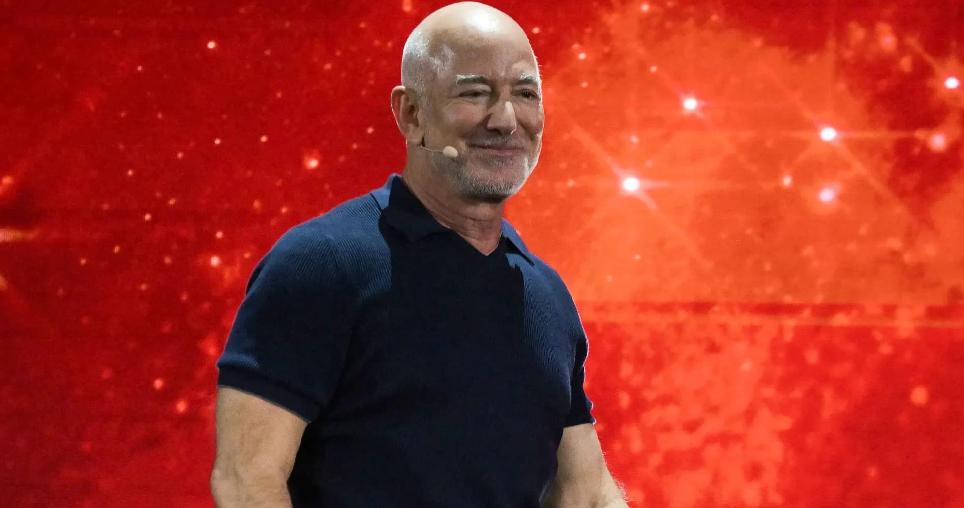 Person speaking at event with red background
