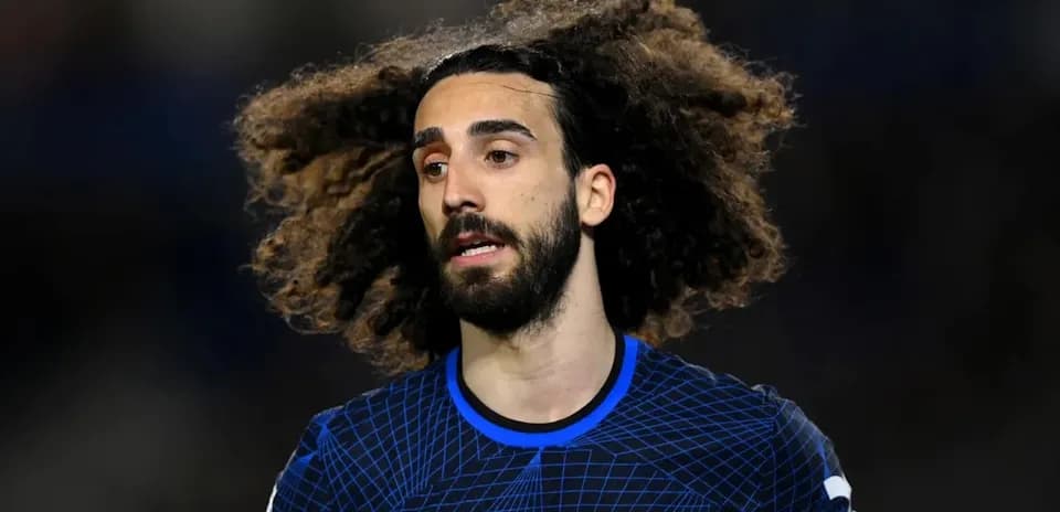 Player with curly hair wearing Chelsea kit