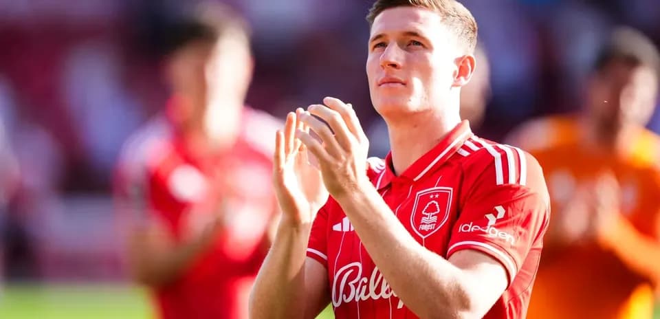 Player applauding fans in red team kit