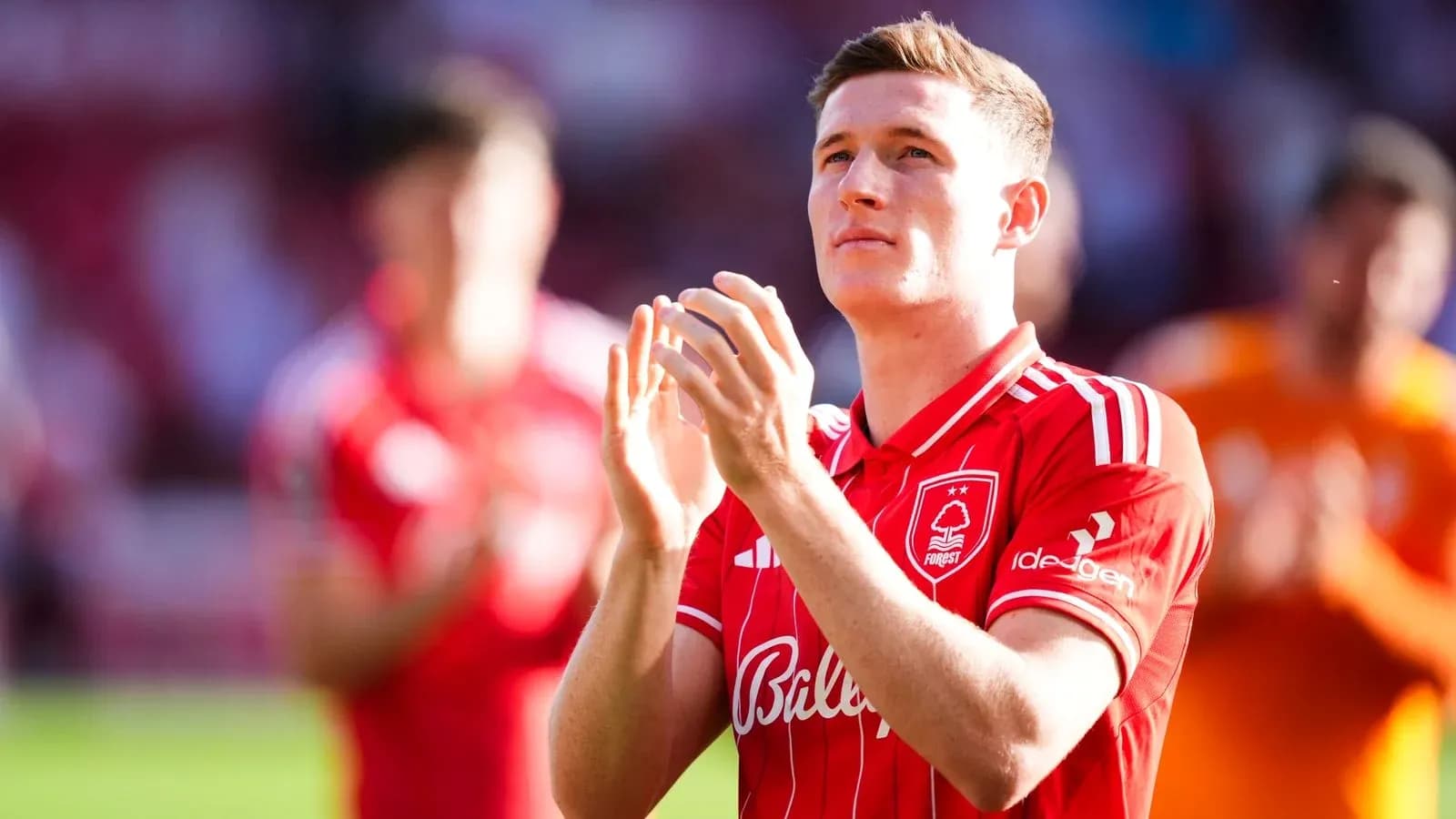 Player applauding fans in red team kit