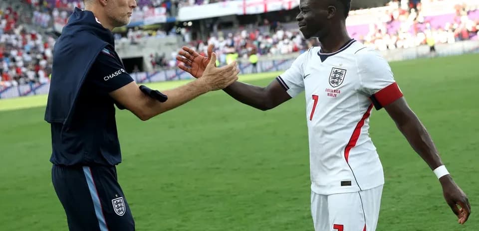 Coach and player shaking hands on the field
