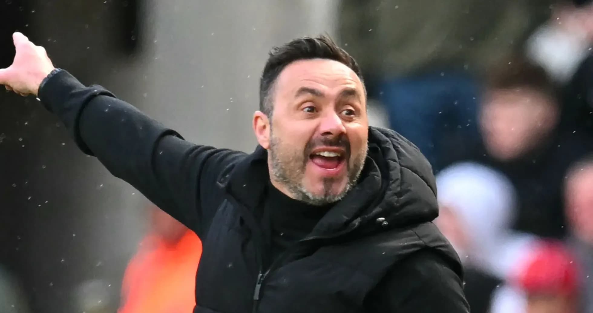 Coach gesturing during a match from the sidelines