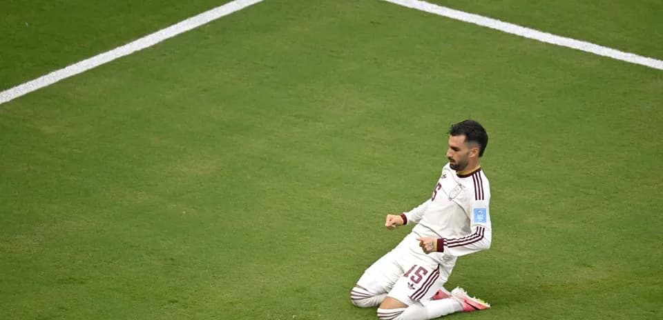 Player celebrating on the field after scoring goal
