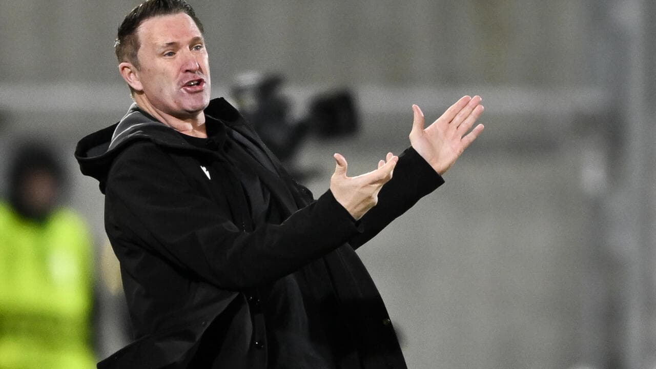 Coach gesturing during a match on the sidelines
