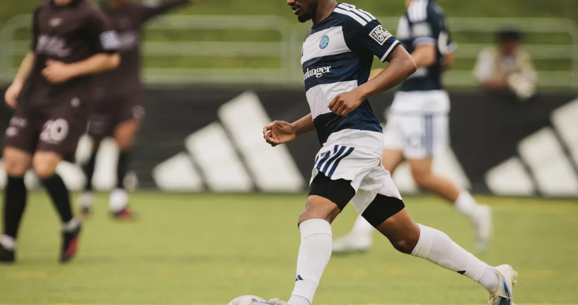 Player dribbling the ball during football match