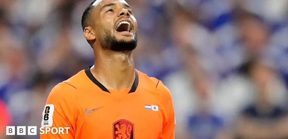 Goalkeeper in orange kit reacting during match