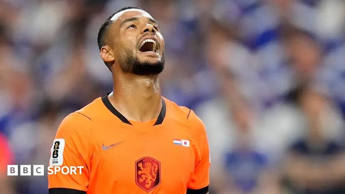 Goalkeeper in orange kit reacting during match