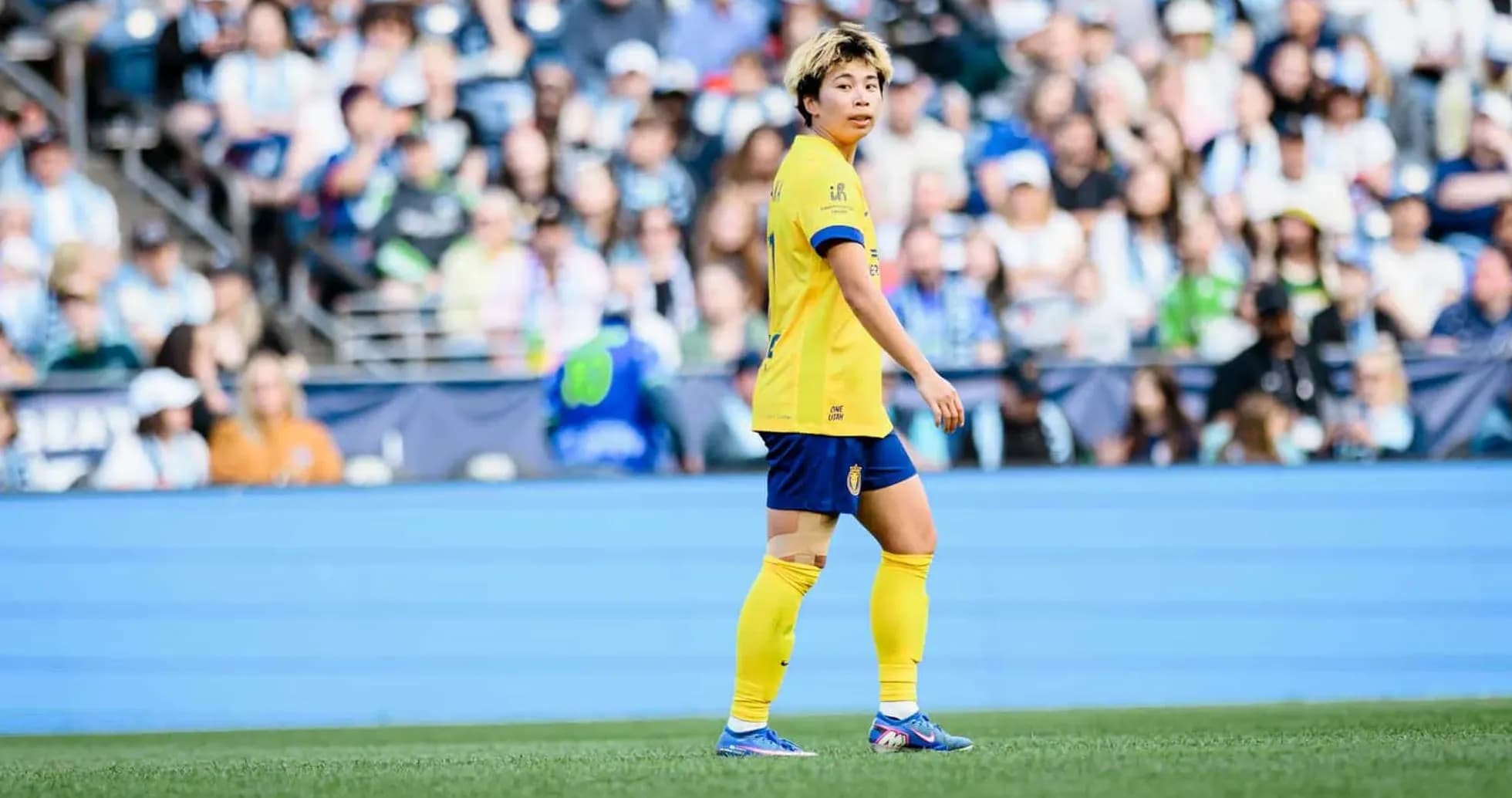 Player in yellow jersey during NWSL match