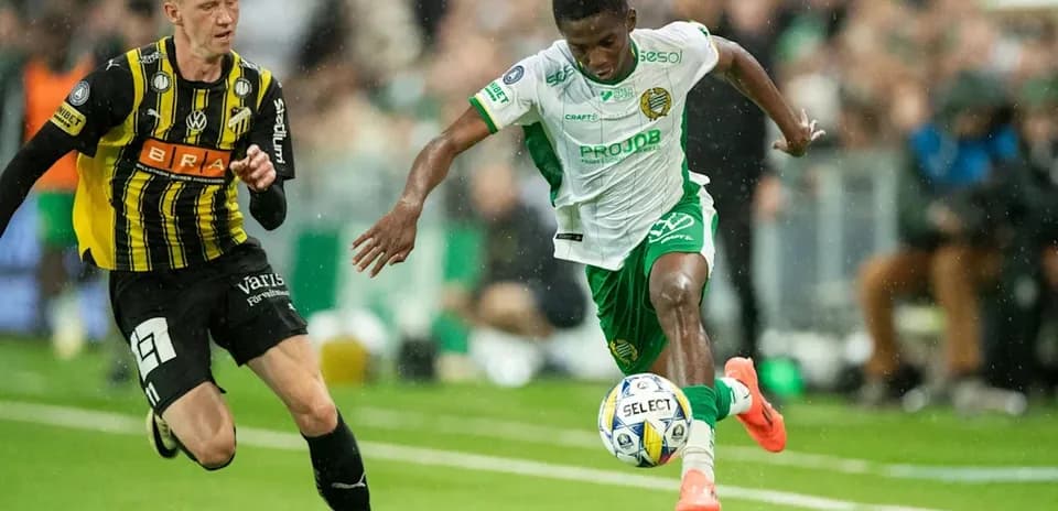 Player dribbling past opponent during football match