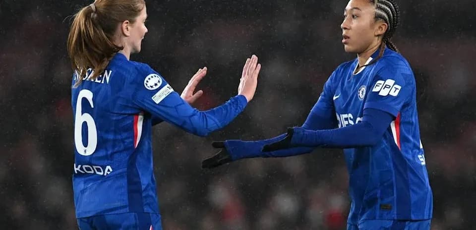 Two Chelsea players exchanging a high five during match