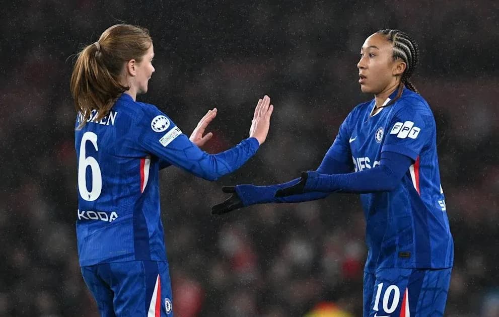 Two Chelsea players exchanging a high five during match