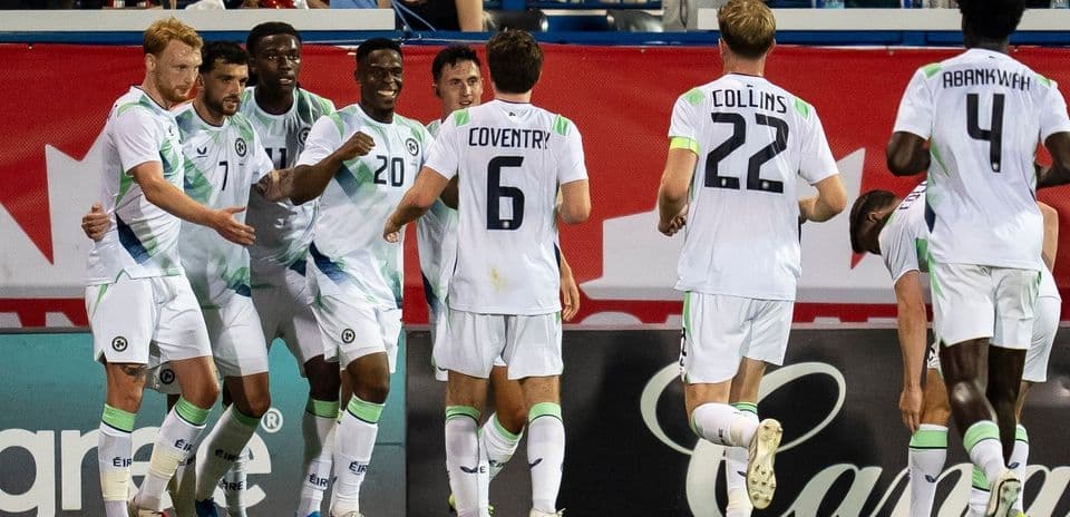 Players celebrating a goal on the field