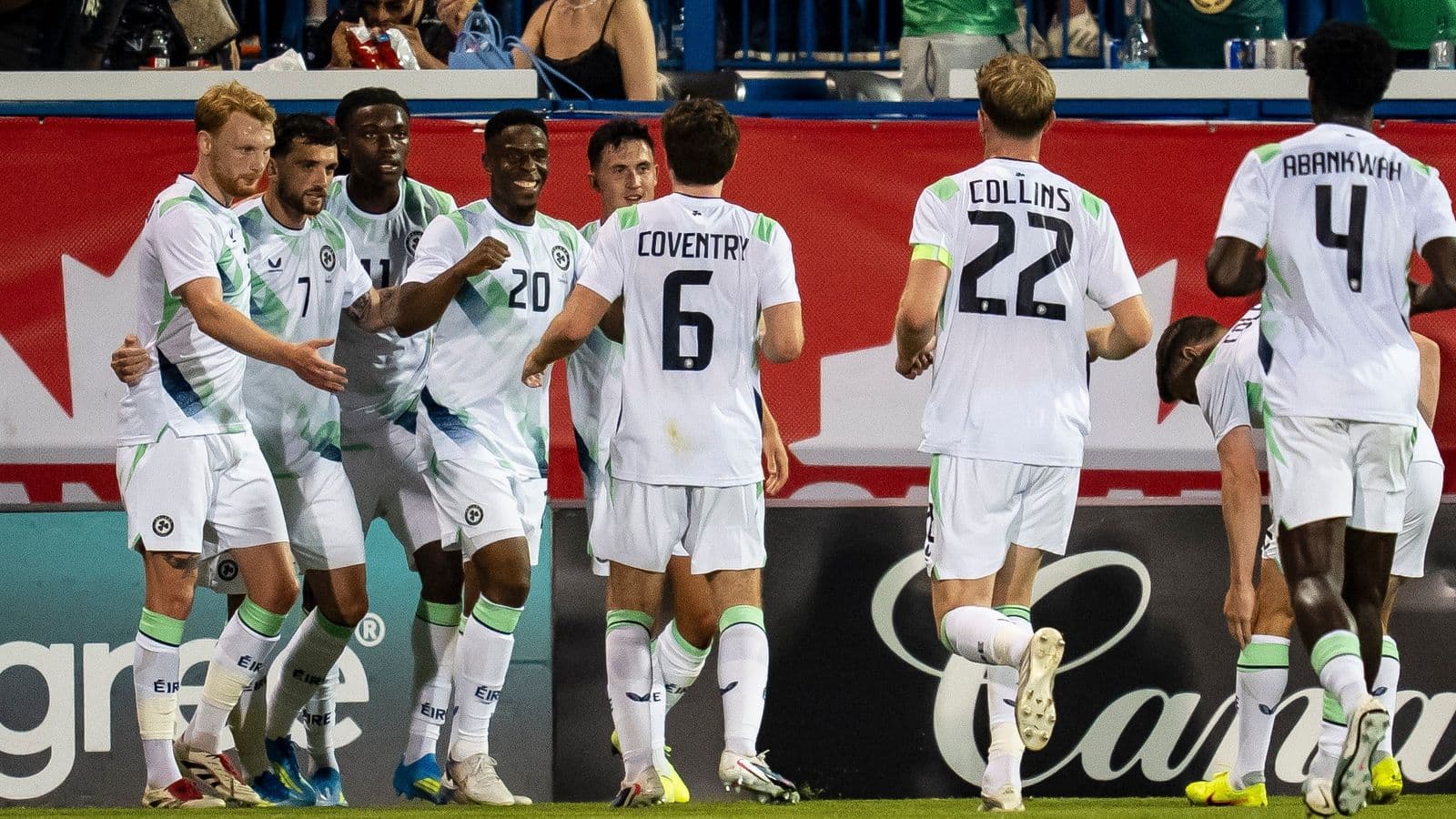 Players celebrating a goal on the field