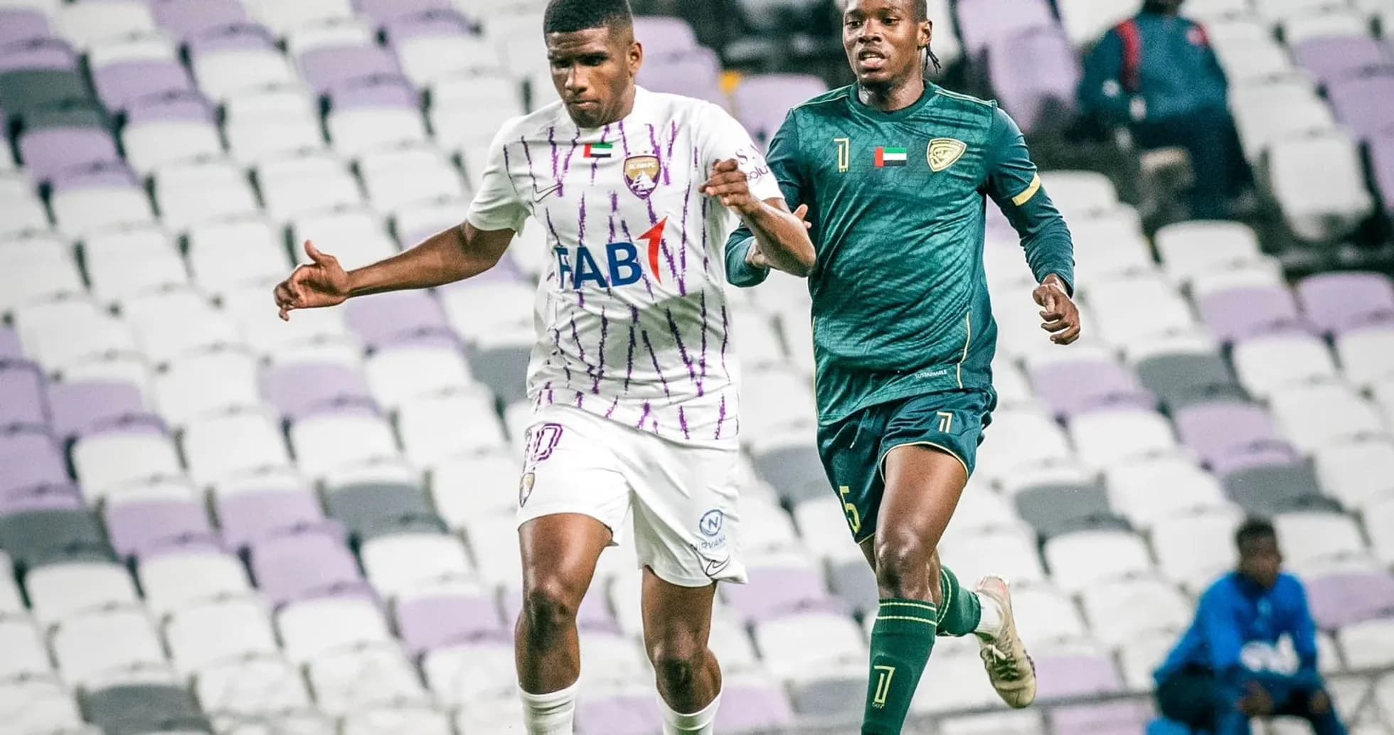 Al Wahda U23 player dribbling past Khorfakkan U23 goalkeeper