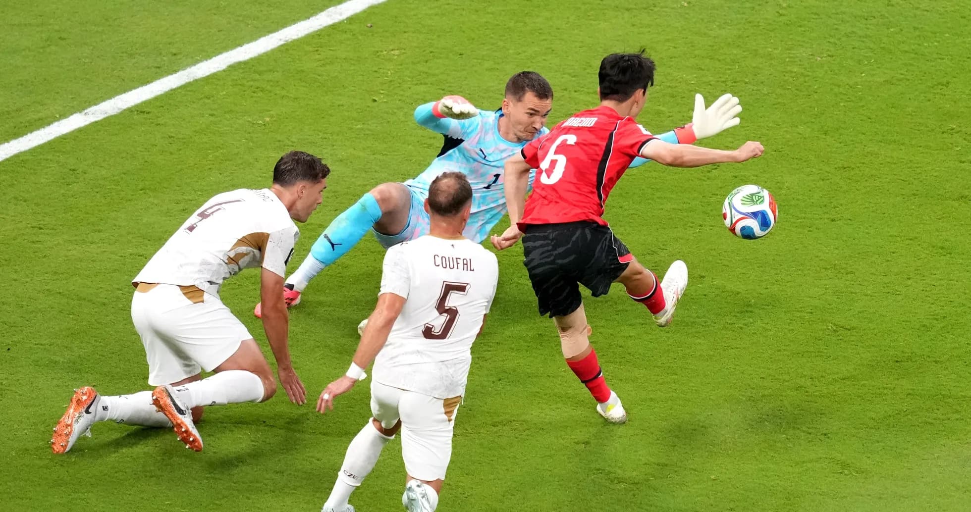 South Korean player attempts to score against Czech goalkeeper
