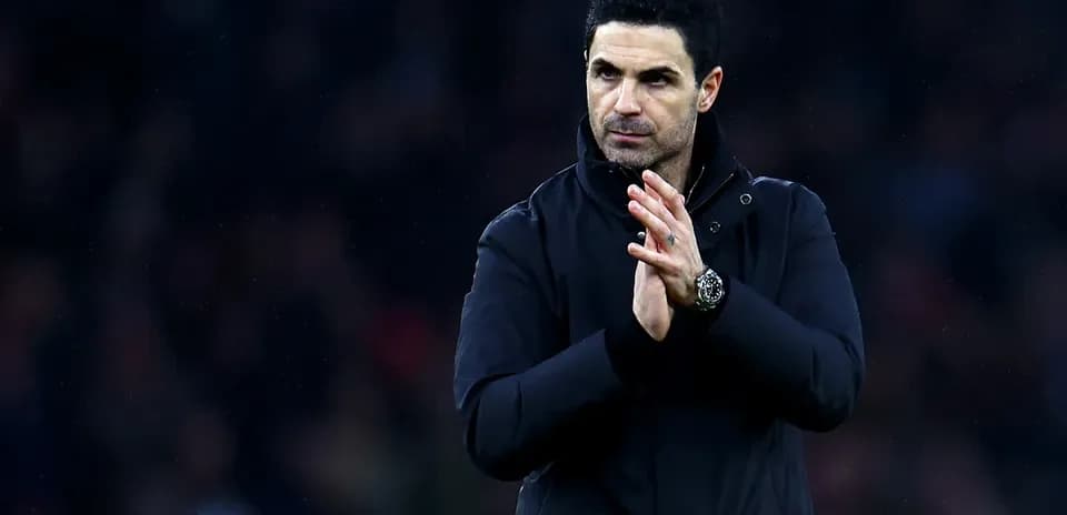 Manager clapping during a match on the sidelines