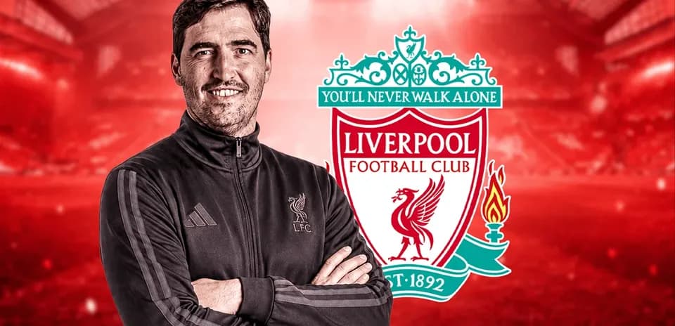 Man in Liverpool FC jacket with club logo backdrop